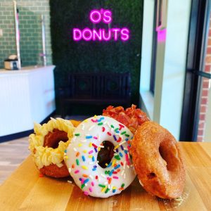 four donuts with the O's Donut Sign