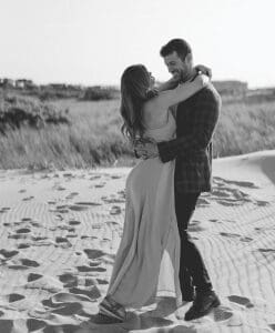 Susie Evans and Clayton Echard embracing each other on the beach