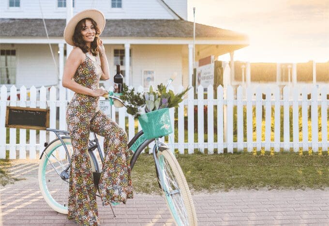 model on bike with fashionable hat and outfit