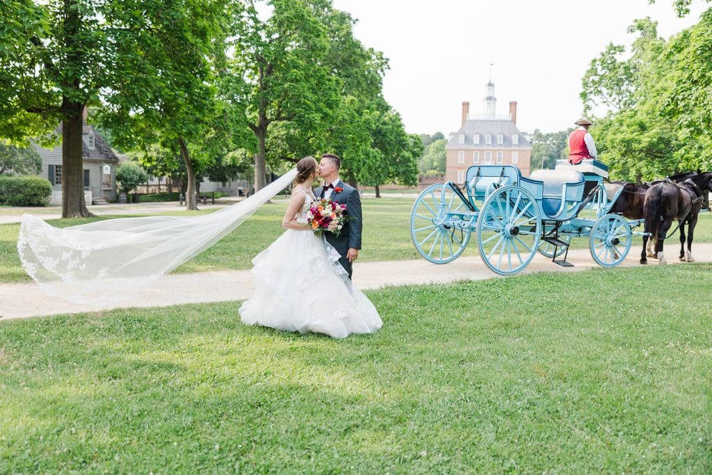 Wedding Couple in front of Palace Carriage. Photo by Mattie Wezah Photography