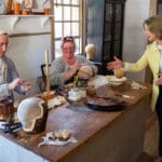 Samantha Brown meets master wig maker Debbie Turpin and apprentice J Benton Parker inside her colonial wig shop. 