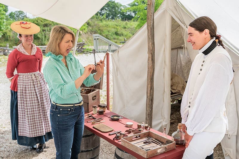 PBS host Samantha discovers Revolutionary War era medical tools with living history manager Gretchen Johnson at the American Revolution Museum Continental Army encampment.